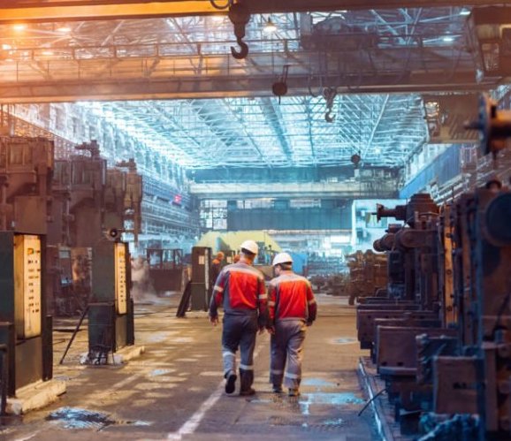Featured image shows two engineers walking through a manufacturing facility. Photo via MxD.